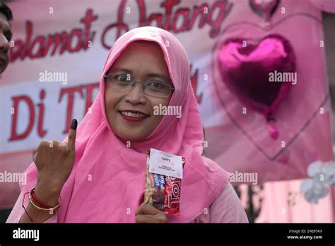 A Woman Shows Her Inked Finger Marking That She Has Already Voted