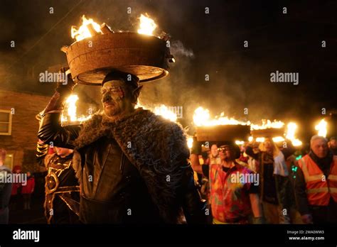 Men, known as guisers, carry burning whisky barrels through the streets during the Allendale Tar ...