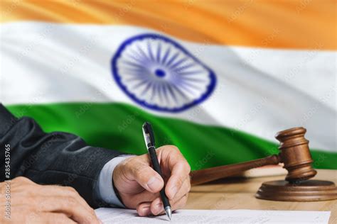 Judge Writing On Paper In Courtroom With India Flag Background Wooden