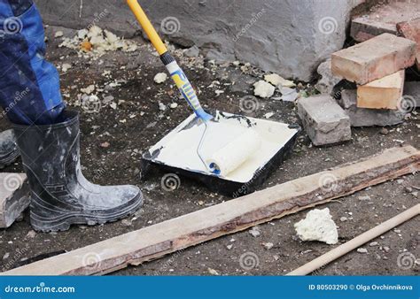 Set Of Painter Paints A Wall With A Roller Puttying Walls Worker In