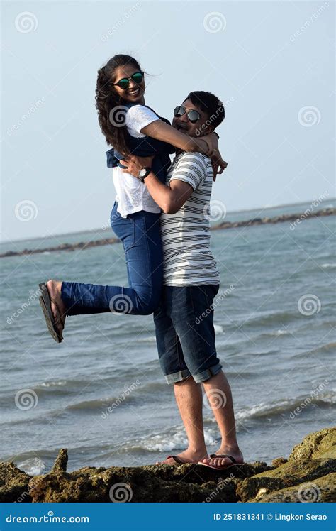 The Young Couple Hugging Against The Sea And Sky Man Lifted Up Woman