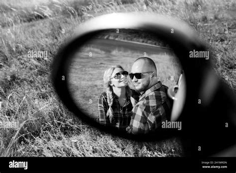 Traveling By Car Of A Young Couple Of A Guy And A Girl In Plaid Shirts