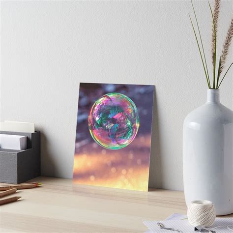 A Soap Bubble Floating On Top Of A Wooden Table Next To A White Vase