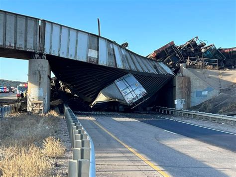 Truck driver killed when train derails, railroad bridge collapses in ...