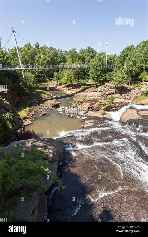 The Liberty Bridge A Curved Suspension Bridge Crosses The Reedy River