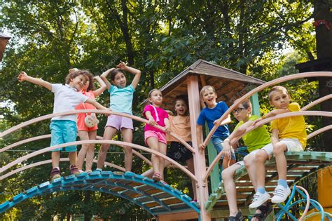 Premium Photo | The little kids stand on a bridge in the playground