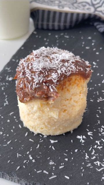 A Pastry With Chocolate Frosting And Sprinkles Sits On A Slate Board