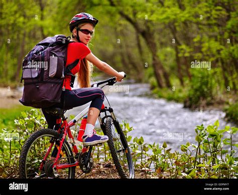 Bicycle Girl With Big Rucksack Cycling Fording Throught Water Stock