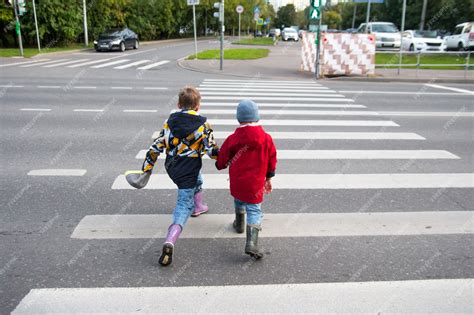 Premium Photo Children Cross The Road Through A Pedestrian Crossing