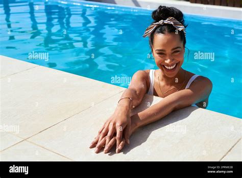 Happiness is a day at the pool. a beautiful young woman relaxing in a ...