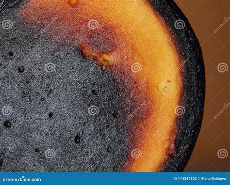 Pancakes Burned During Cooking On The Background Of A Wooden Surface