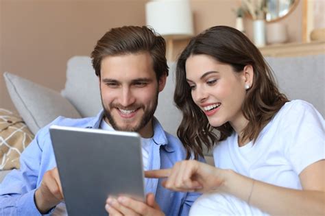 Premium Photo Happy Couple Sitting And Planning New Home Decoration At Home With A Tablet