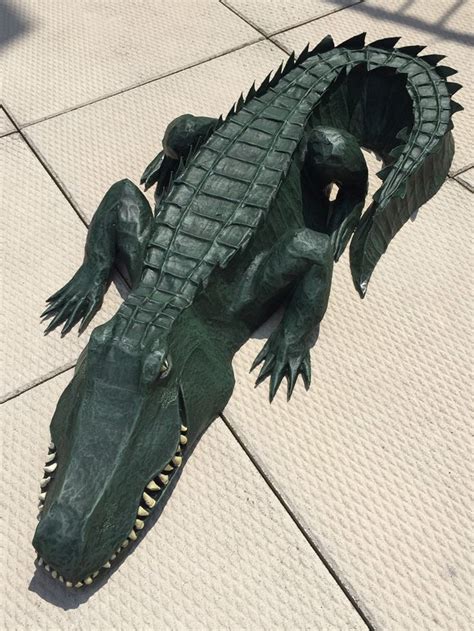 Paper maché alligator waterproofing and painting Manning Makes