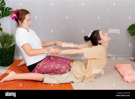 Asian Woman Getting Traditional Thai Stretching Massage By Therapist