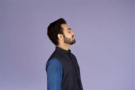 Side View Of Peaceful Indian Man With Closed Eyes Relaxing On Lilac