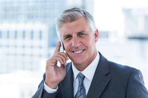 Premium Photo Smiling Businessman Having A Phone Call