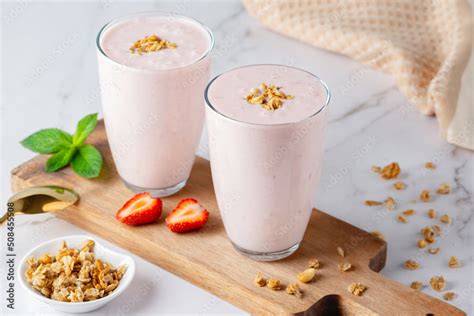 Yogurt Buttermilk Or Kefir With Granola And Strawberry Yogurt In Glass On Light Background