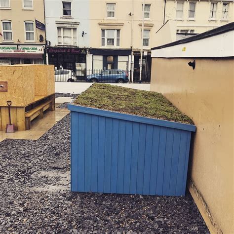 A Bespoke Bike Slot In Shed With A Green Roof And Painted Cladding