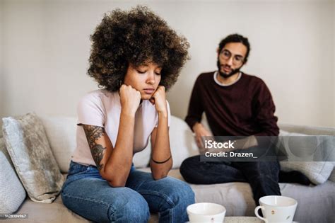 Multiracial Millennial Couple At Home Discussing Relationship