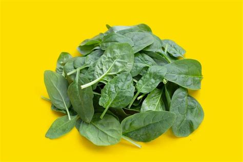 Premium Photo Spinach Leaves On Yellow Background