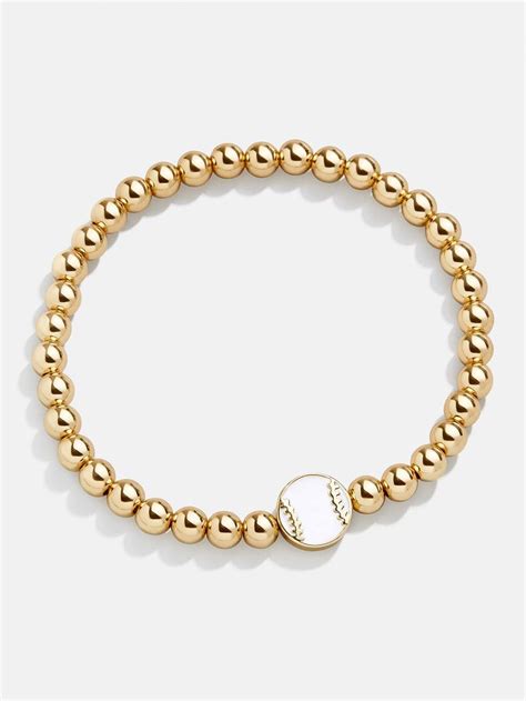 A Gold Beaded Bracelet With A Baseball Charm On The Clasp And A Small