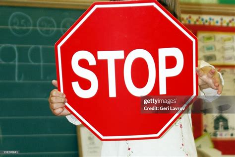 Child Holding Stop Sign In Classroom High Res Stock Photo Getty Images