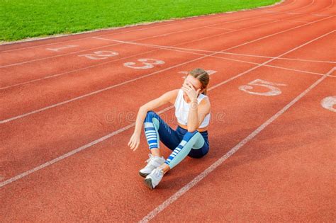 Tired Woman Runner Taking A Rest After Run Sitting On The Running Stock