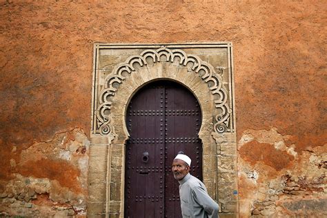 A Man Walks In Front Of Doors In Walls Of Rabat S Medina Damir Sagolj