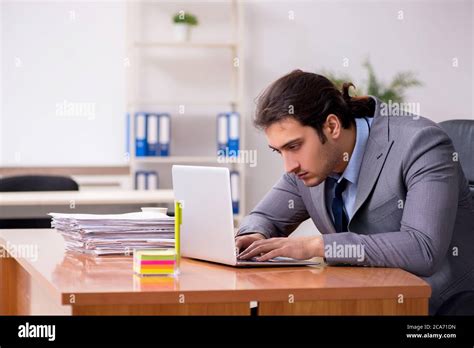 Young employee sleeping in the office Stock Photo - Alamy