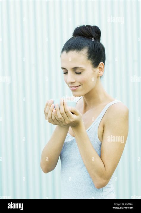 Woman Holding Bowl In Cupped Hands Eyes Closed Stock Photo Alamy