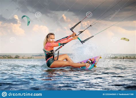 Front View Professional Kite Surfer Woman Rides On A Board With A Plank