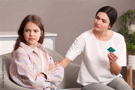 Mother Talking With Her Teenage Daughter About Contraception At Home Sex Education Concept