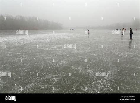 Skating on frozen lake Stock Photo - Alamy