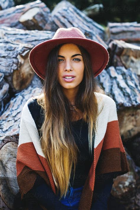 "Hipster Woman Sitting In Front Of A Stack Of Trunks." by Stocksy ...