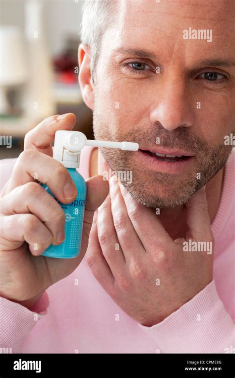 Man Using Mouth Spray Stock Photo Alamy