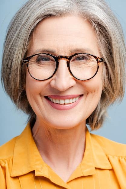 Premium Photo Smiling Senior Woman Wearing Eyeglasses Looking At Camera Isolated On Blue