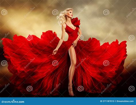 Beautiful Woman In Red Dress Flying On Wind Over Fantasy Sky Background Fashion Model In