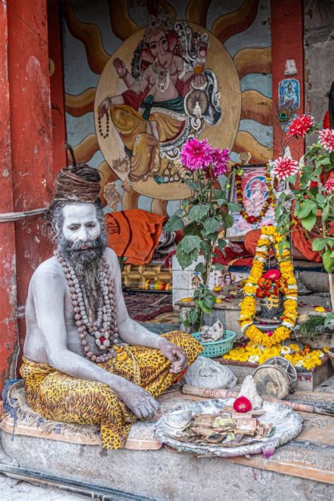 Old Sadu Painted In White Ash Is Meditatingin An Arch Of The Hostel For