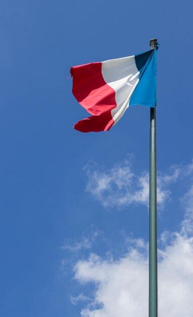 Premium Photo Flag Of France Waving In The Wind On The Blue Sky