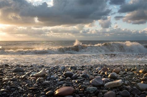 Premium Photo | Sea storm at sunset ashore with beautiful clouds