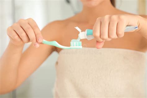 Woman Applying Toothpaste On Brush Indoors Closeup Stock Image Image