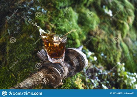 Whiskey Glass On The Wooden Stick With Nature Green Grass Background