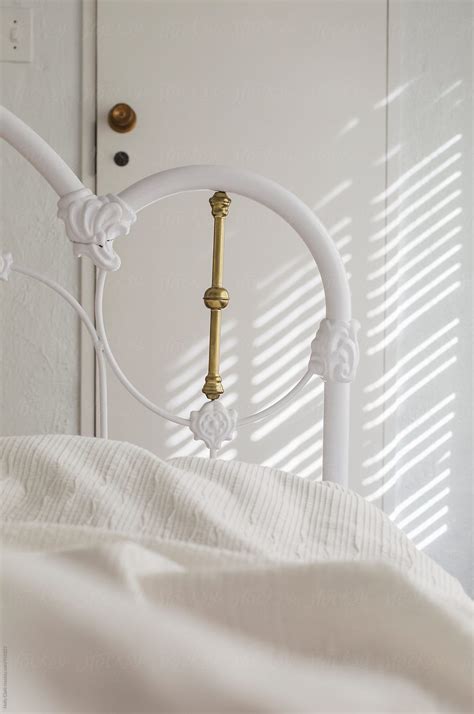 Detail Of White Bed Frame Bedding And Wall With Shadow Del