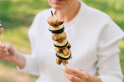 Premium Photo Mature Woman 50 Years Old Eating Grilled Bbq Vegetables