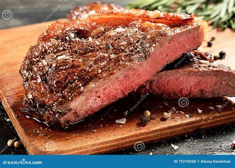 Rare New York Strip Steak On Wooden Board Selected Focus Stock Photo