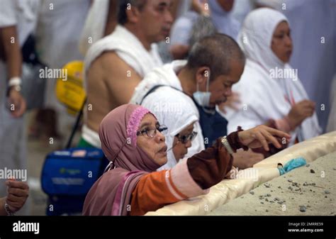 Muslim Pilgrims Cast Stones At The Huge Stone Pillar In The Symbolic