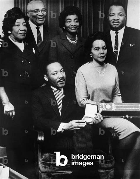 Image of Martin Luther King, Jr., (seated), with his parents, Martin Luther