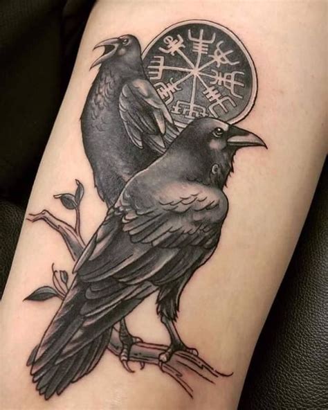 Two Black Birds Sitting On Top Of Each Other Next To A Clock With