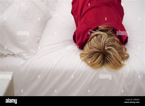 Unhappy Depressed And Sad Mature Woman Lying Face Down In Bed In