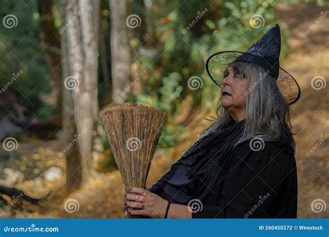 White Haired Witch With Hat In Profile In The Forest Stock Photo